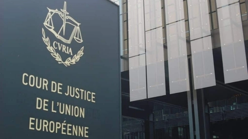 Dark exterior panel sign reading Cour de Justice de l'Union Européenne with the gold CURIA emblem above